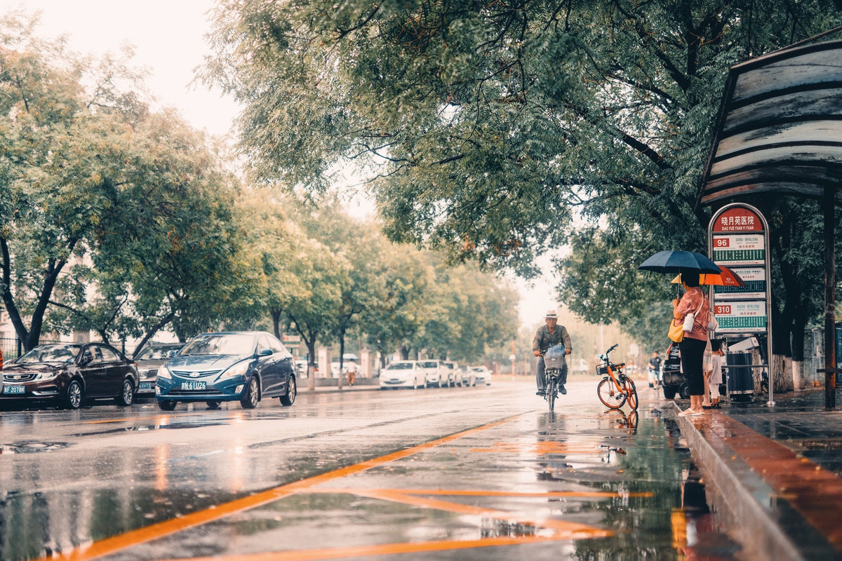 Straße bei Regen mit Fahrrad Fahrer*in